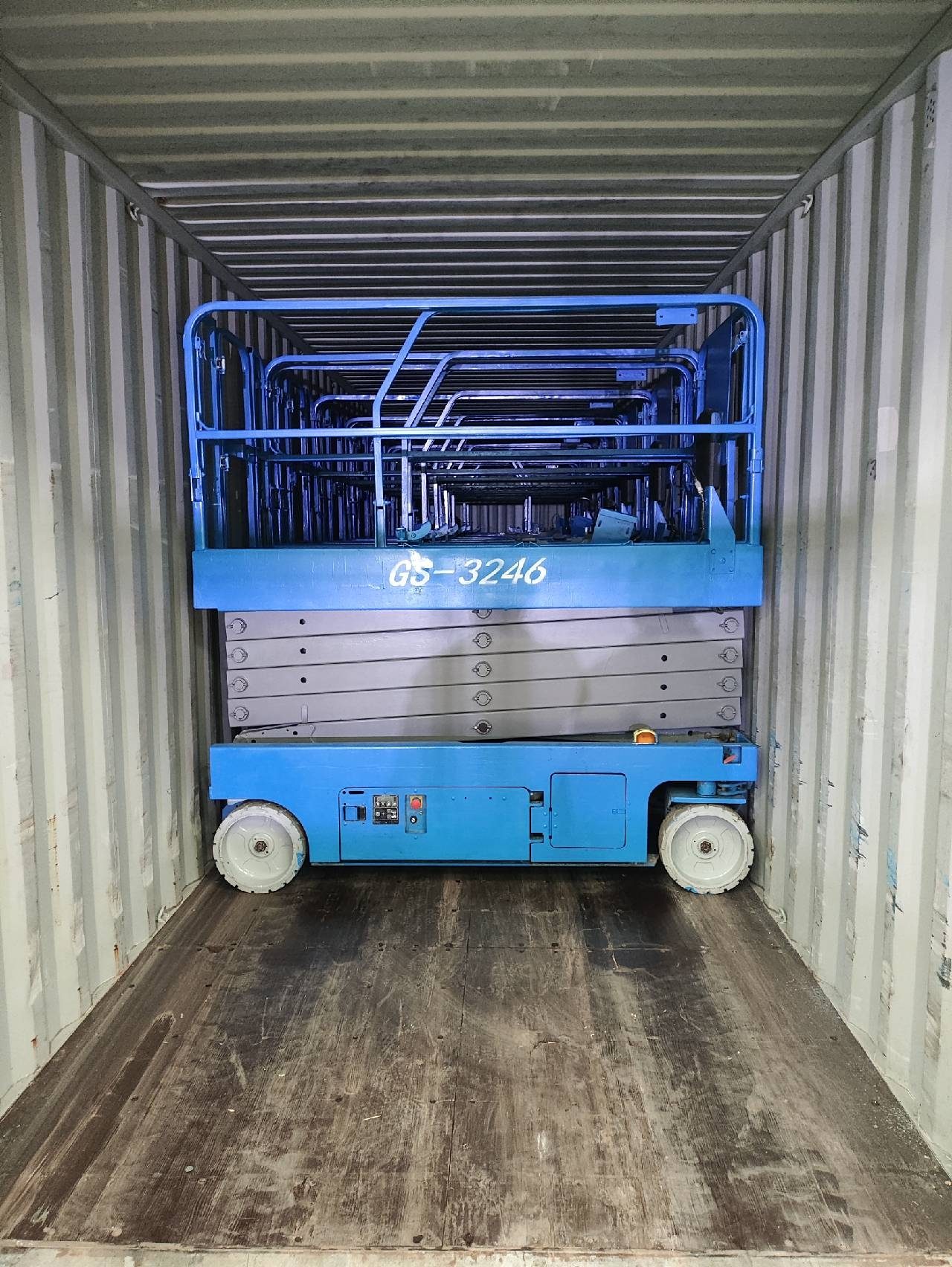Scissor lift secured inside a shipping container